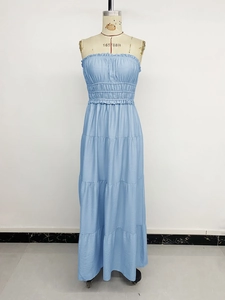 Detail of smocked high waist and tiered ruffle hem on this light blue strapless maxi dress