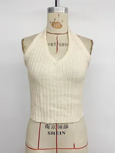Detail of cream ribbed knit halter top featuring a V-neck design on a studio mannequin