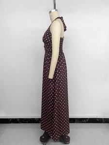 Detail view of brown polka dot halter maxi dress with open back and cinched waist