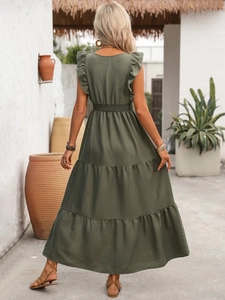 Detail of olive green tiered maxi dress featuring an elastic high waist and ruffled shoulders