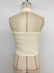 Detailed back view of off-white ribbed halter top on mannequin showing knit texture