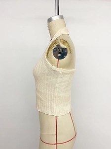 Detailed side view of beige ribbed knit halter top featuring a slim fit cropped cut