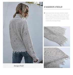 Detail shot of distressed cuffs and textured multi-color knit fabric on high neck sweater