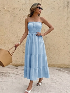 Detail of light blue strapless smocked maxi dress with tiered ruffles and woven fabric