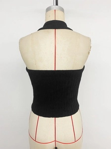 Detail shot of black ribbed knit halter crop top showing backless cut and fabric texture