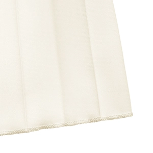 Detailed close-up of white pleated hemline featuring clean stitching and textured fabric