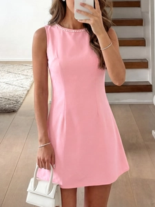Detailed view of the beaded neckline and sleeveless pink A-line dress for women