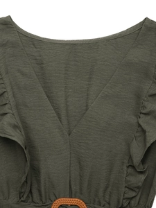 Detail of V-neckline with ruffled edges and brown woven buckle on olive green dress