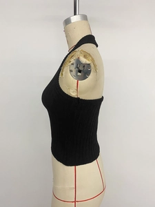 Side view of black ribbed knit halter neck crop top on a dress form model