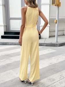 Elegant sleeveless yellow jumpsuit with bow back and textured floral jacquard fabric