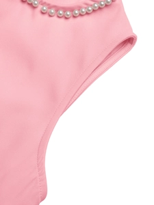 Close-up of elegant round neckline with premium white pearls on pink sleeveless dress