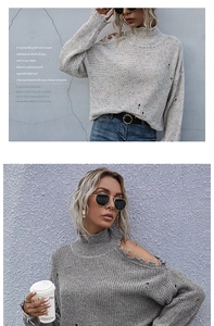 Close-up of women's gray cold-shoulder knit sweater with high neck and distressed details