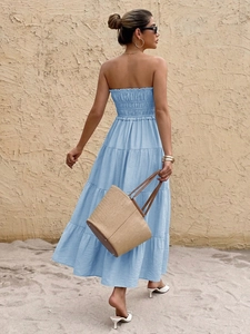 Detail view of the smocked back and tiered ruffle skirt on this light blue summer maxi dress