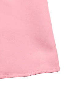 Detailed view of pink fabric hem with fine twill texture and professional stitching