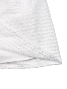 Détail de la texture en maille blanche superposée et des coutures fines sur l'ourlet
