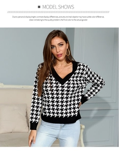 Close-up of women's V-neck houndstooth knit sweater with black ribbed cuffs and neckline