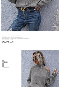 Detail of grey cold-shoulder knit sweater with distressed fringe and turtleneck style