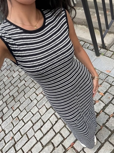 Detail of knit striped maxi dress showing ribbed texture and black finished armholes