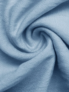 Close-up of elegant light blue knit fabric showing soft texture and silky sheen