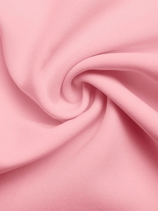 Detail shot of soft pink elegant fabric showing smooth texture and draped folds