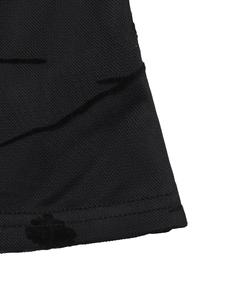 Detailed macro view of black mesh fabric with velvet floral flocking and double stitching