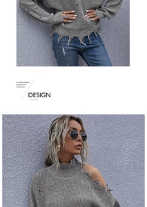 Detail of grey chunky knit off-shoulder sweater with distressed ripped hole textures