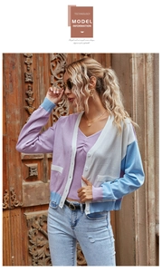 Detail of color block V-neck knitted cardigan with white buttons and patch pockets