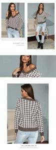 Detail of V-neck houndstooth knit sweater with ribbed cuffs and brown pattern texture