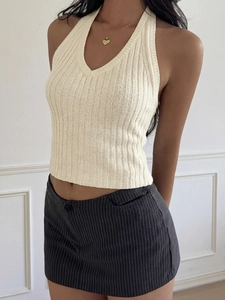 Detail of cream ribbed knit halter top with deep V-neck and slim fit texture