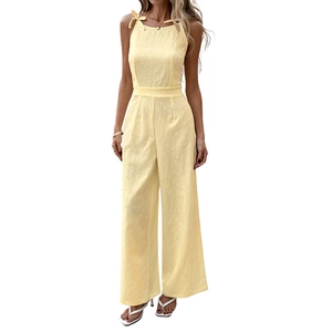 Elegant pale yellow sleeveless halter jumpsuit with daisy jacquard and bow tie waist detail