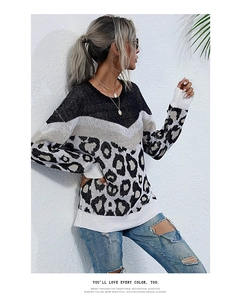 Detail of loose-fit leopard print patchwork sweater with round neck and ribbed cuffs