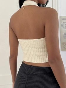 Detail of beige knit halter top showing the sexy open back and ribbed fabric texture