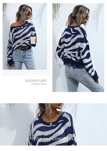 Close-up of blue and white zebra pattern knit sweater with distressed fringe hem details