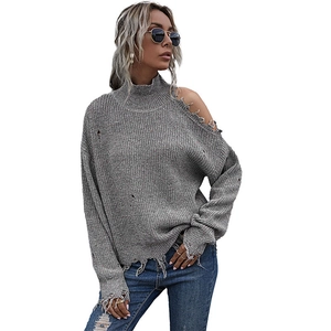 Off-shoulder grey knit sweater with distressed ripped details and high collar style