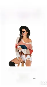 Detail view of V-neck patchwork knit sweater with cold shoulder and frayed hem texture