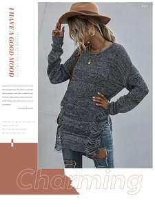Detail of grey knit oversized sweater featuring fashion hollow-out shredded side seams