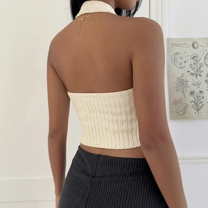 Women's beige halter neck crop top with backless design and ribbed knit texture