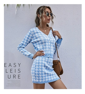 Detail of blue and white houndstooth knit cardigan and mini skirt set with buttons