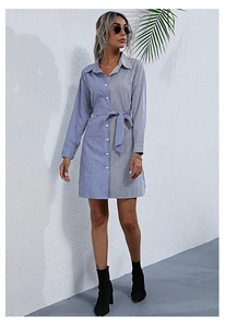 Detailed close-up of a striped shirt dress featuring a waist tie and notched lapel design