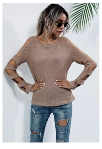 Close-up of ribbed knit texture with cut-out details on long sleeve sweater