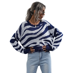 Women's crewneck knit sweater with navy zebra stripes and distressed fringe details