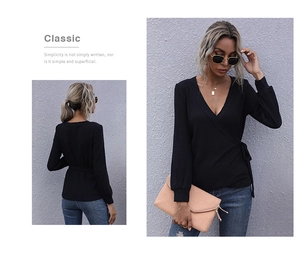 Detail of a black wrap V-neck ribbed top with waist tie and slim fit silhouette