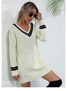 Detail of V-neck knitted sweater dress with contrast stripes and cable knit texture