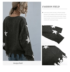 Macro detail of the star jacquard pattern and distressed fringe hem on the knit sweater
