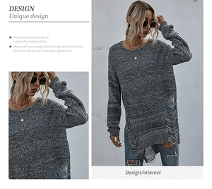Detail of ripped hem on gray longline knit sweater with distressed hollow out design