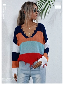 Detail of multi-color striped V-neck sweater with distressed hems and boho fringe edges