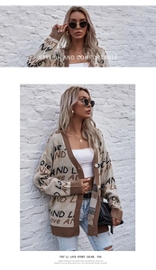 Detailed view of V-neck knitted cardigan featuring brown graffiti text on apricot fabric