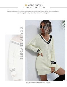Detail of V-neck knit dress showing cable knit pattern and contrast striped trims