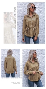 Detail view of khaki French style long-sleeve shirt with waist tie and front pockets