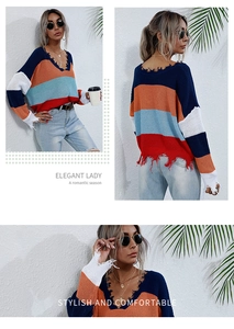 Detail shot of distressed V-neck knit sweater featuring color-block stripes and fringe hem
